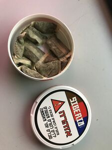 A can of Siberia Snus, showing the contained pouches and container lid